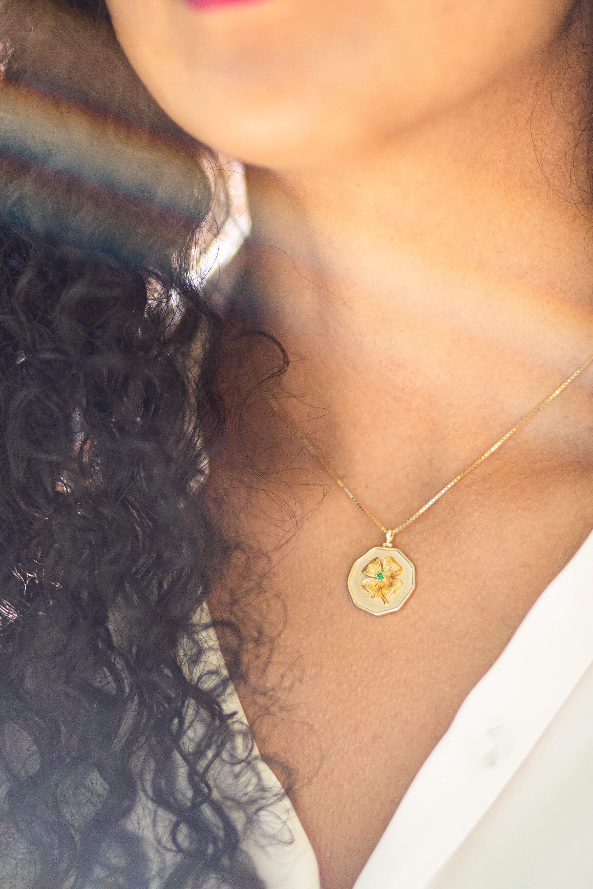 Close-up of silver medallion necklace on white background